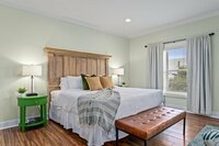 The upstairs primary bedroom has seating for reading or television away from the rest of the house. The door on the left leads to the outdoor deck and the second door leads to a giant bathroom.
| Emerald Palm by Boutiq Luxury Vacation Rentals | Miramar Be
