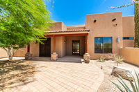 The primary bedroom has a large dresser, fireplace, and a Samsung smart TV, as well as a door that leads out to the back patio and hot tub area.
| The Sonoran by Boutiq Luxury Vacation Rentals | Scottsdale, Arizona